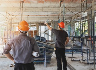 Engineer,Discussing,With,Foreman,About,Project,In,Building,Construction,Site
